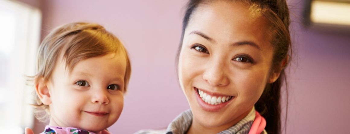 Smiling pediatrician with happy baby