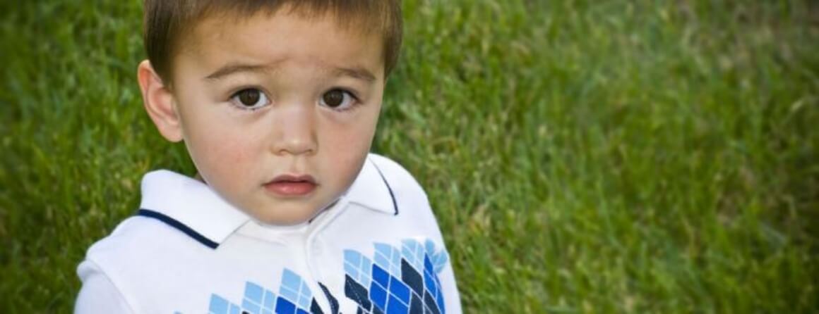 Toddler boy frowning