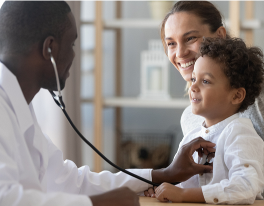 doctor checking childs heart