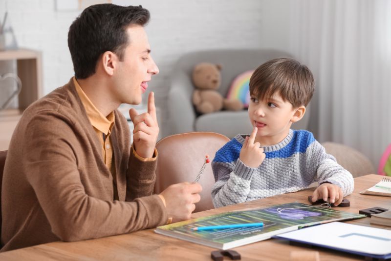 Little boy with speech pathologist in a clinic
