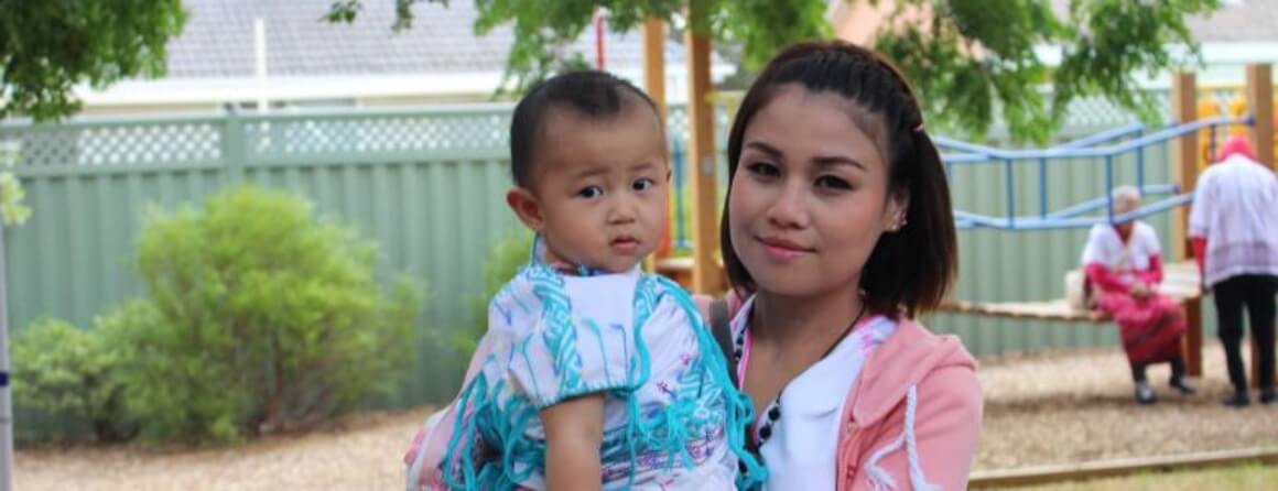 Young woman holding toddler