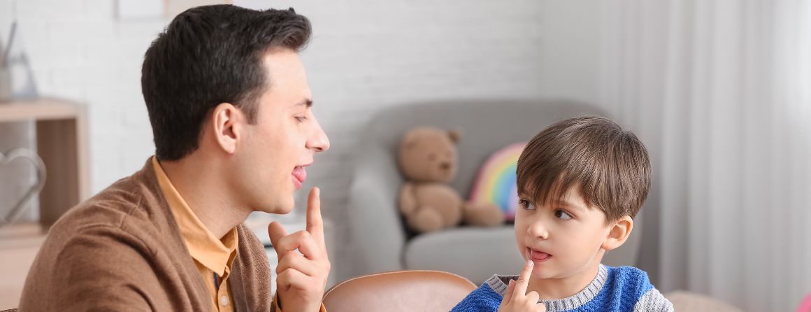 Little boy with speech pathologist in a clinic