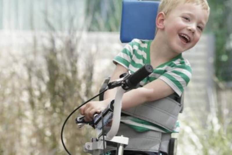 Young boy with cerebral palsy on a bike