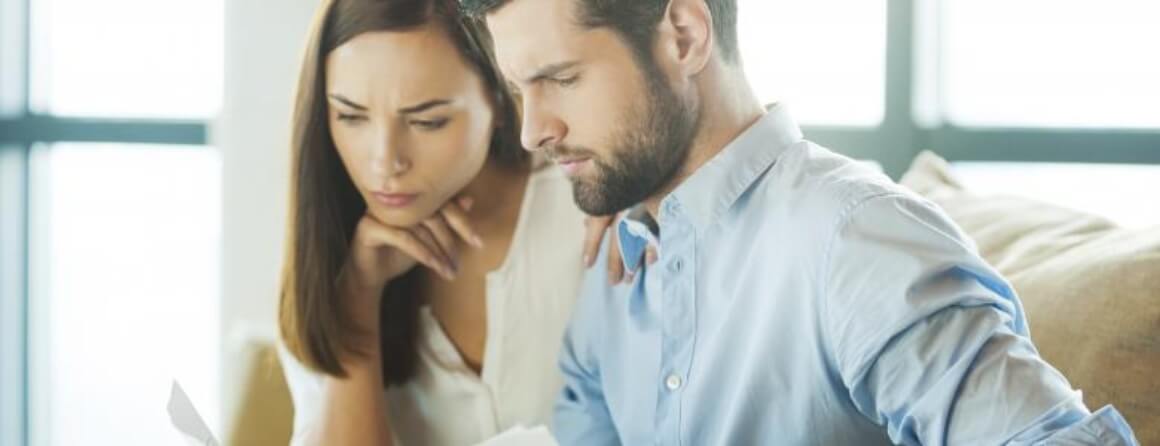 Man and woman studying a report