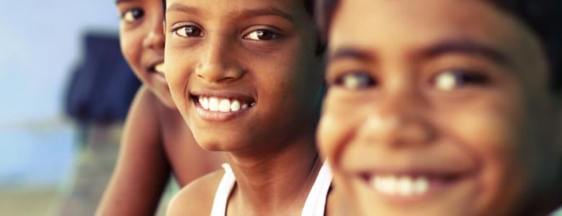Faces of three smiling children