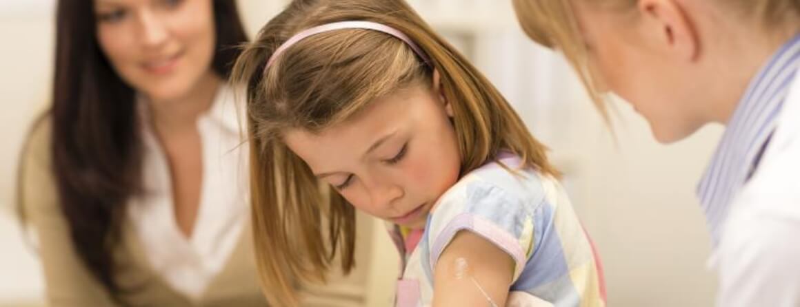 Young girl being vaccinated
