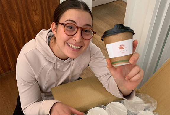 Hannah holding a coffee cup