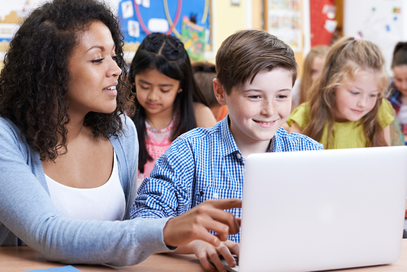 Teacher helping students in a class