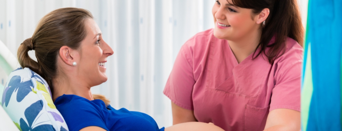A pregnant woman is checked by a health care worker