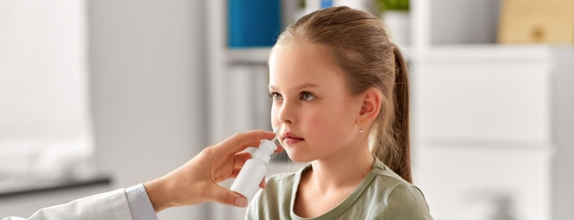 Child being given nasal spray