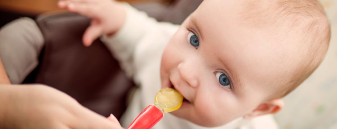 Baby being fed solids