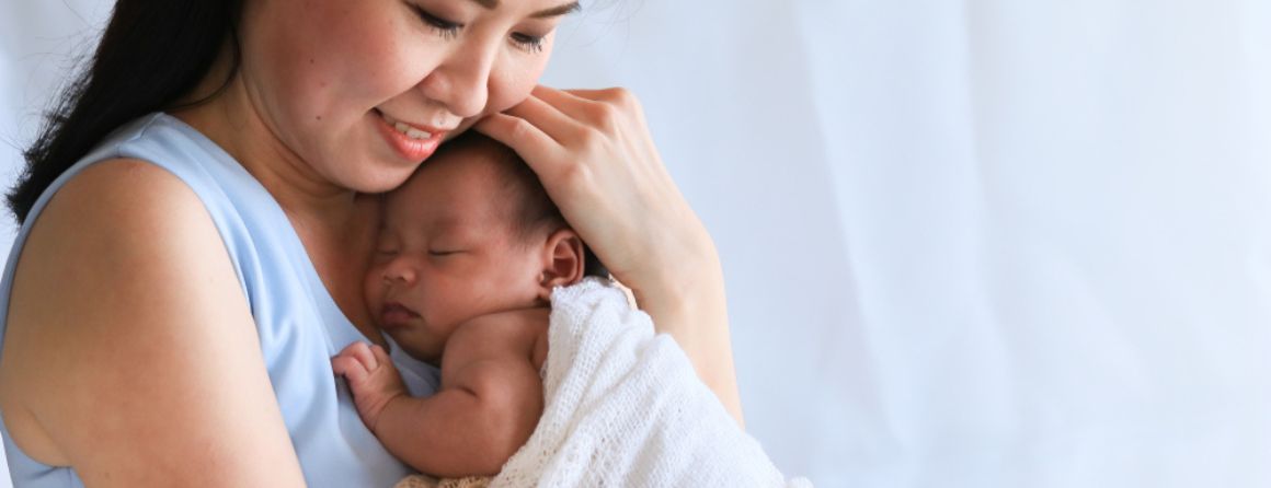 Mother holding young baby