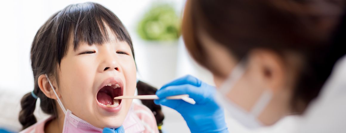 Doctor looking in child's throat