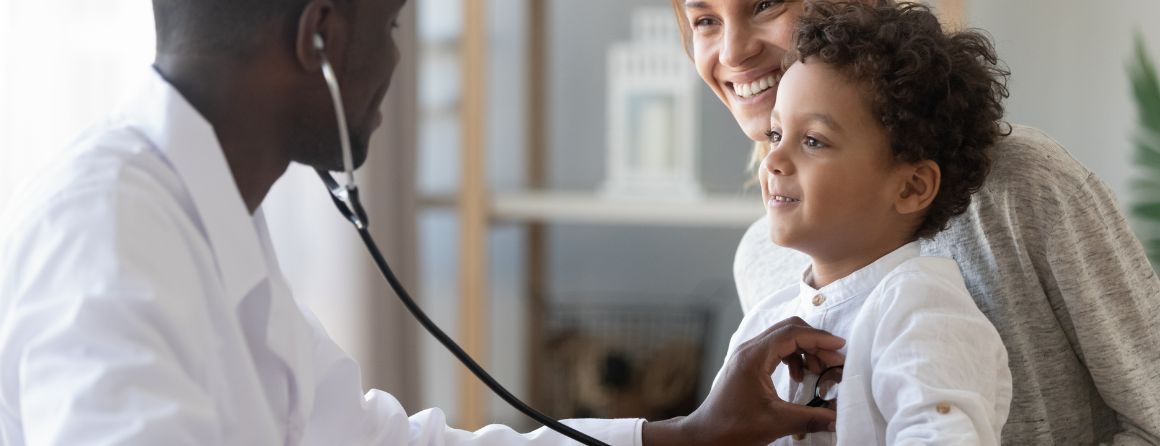 Doctor listening to child's heartbeat