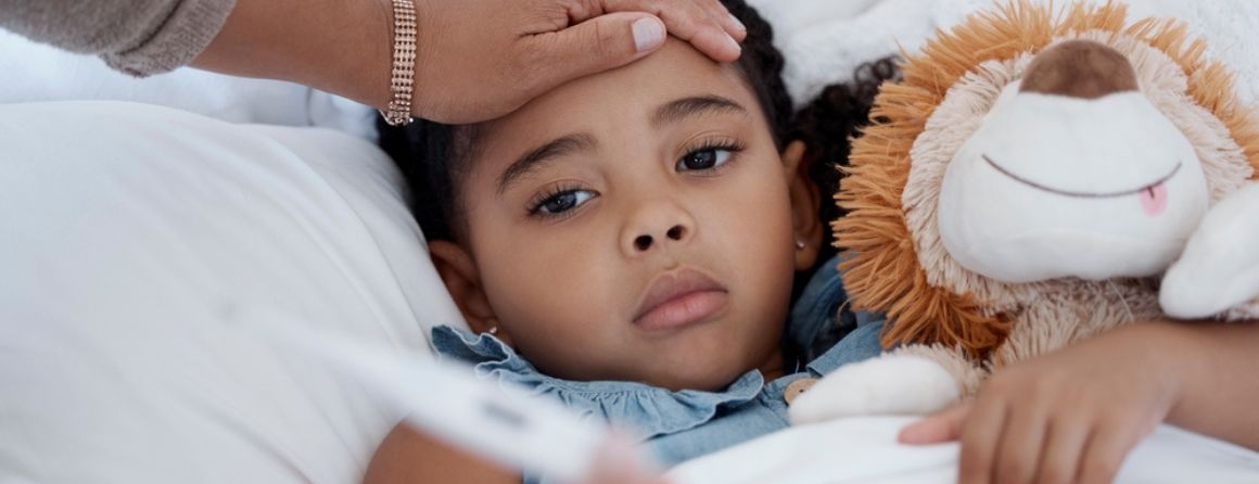 A child has his temperature checked