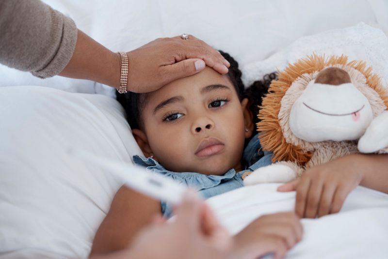 A child has his temperature checked