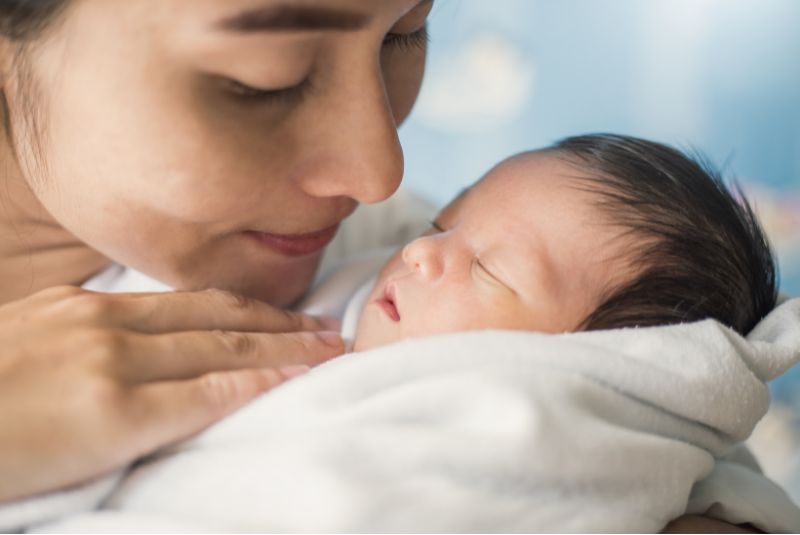 A mother cares for her newborn child