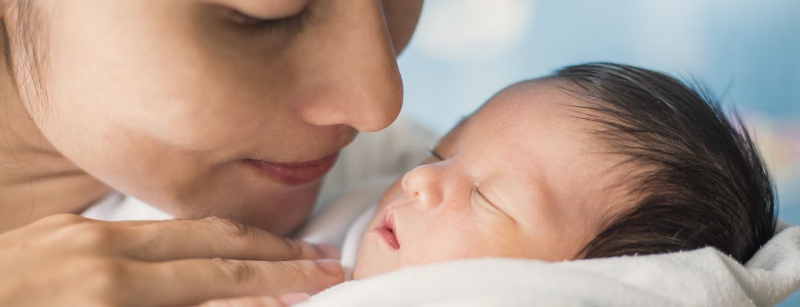 A mother cares for her newborn child