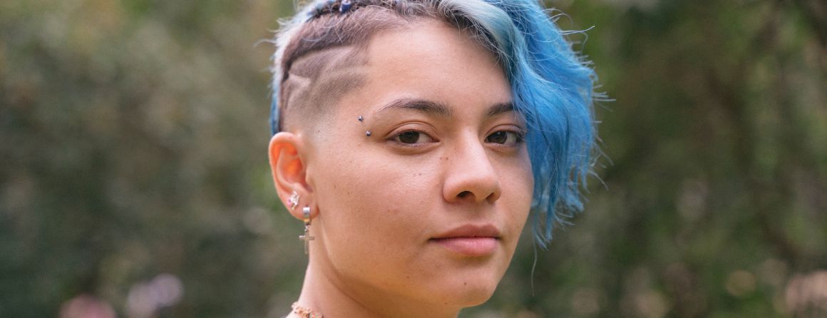 Trans young person looking at camera