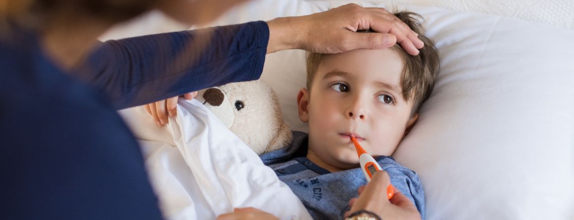 Sick child with a thermometer