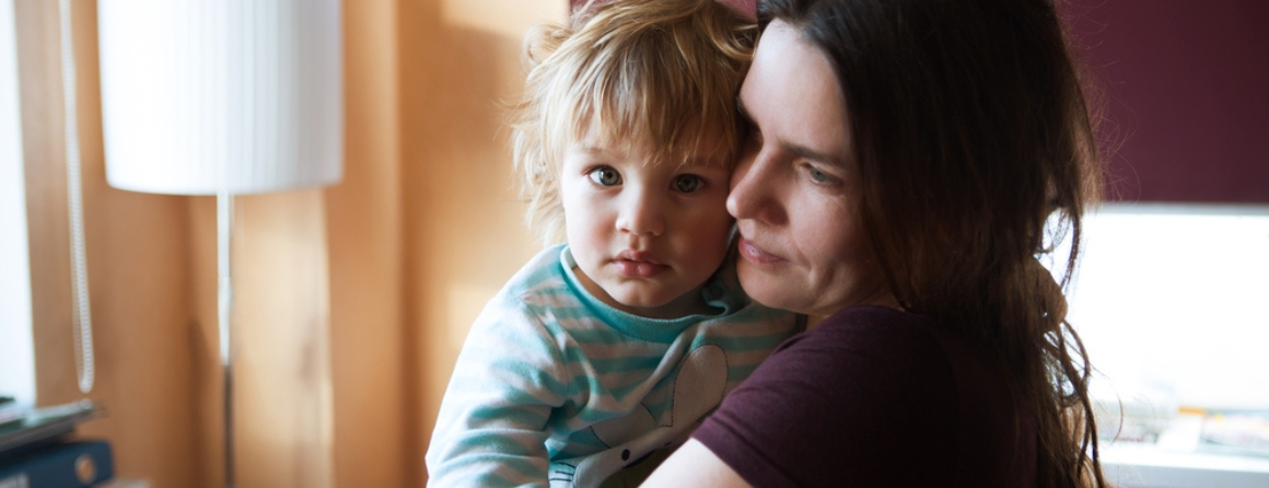 A mother is holding her toddler