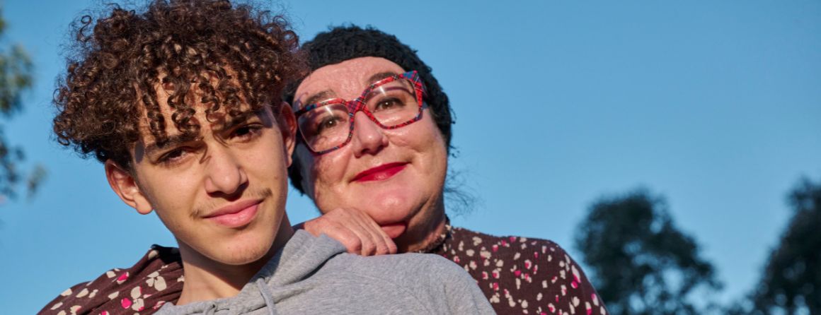 Woman and teenager smiling at camera