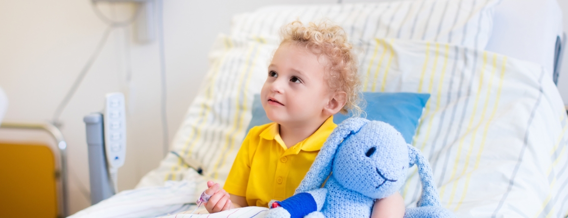 A child receives care in a hospital bed