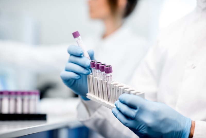 A scientist holding test tubes