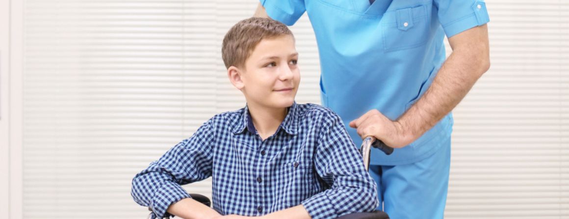 A muscular dystrophy patient in a wheelchair with a nurse