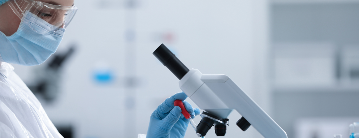 A researcher looking into a microscope
