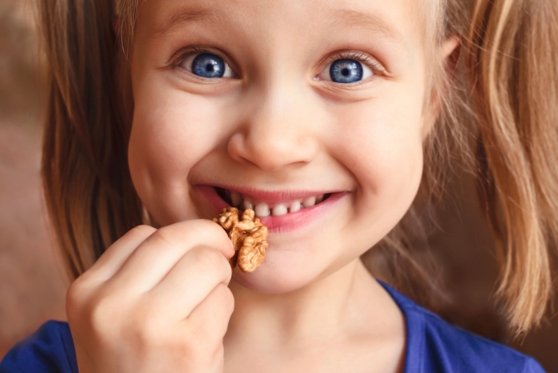 A child holding a nut