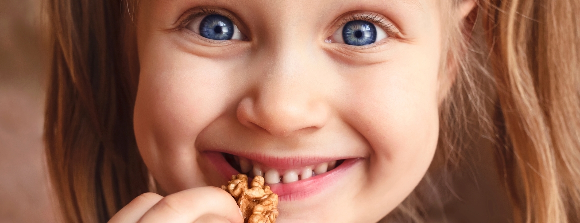 A child holding a nut