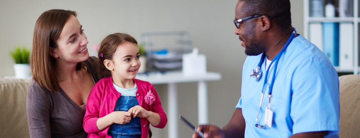 A child with a doctor and mother