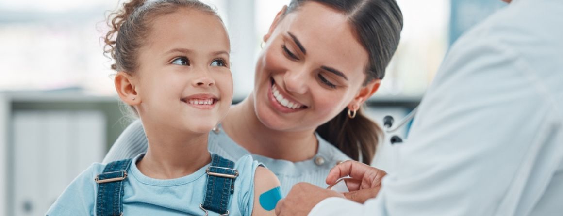 Child with a bandaid, mother and doctor