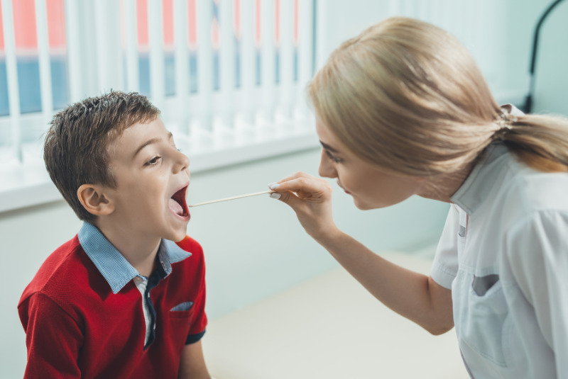 A child is checked for Strep A