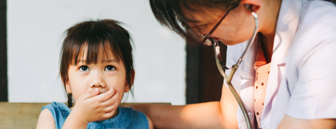 Doctor listening to child's lungs