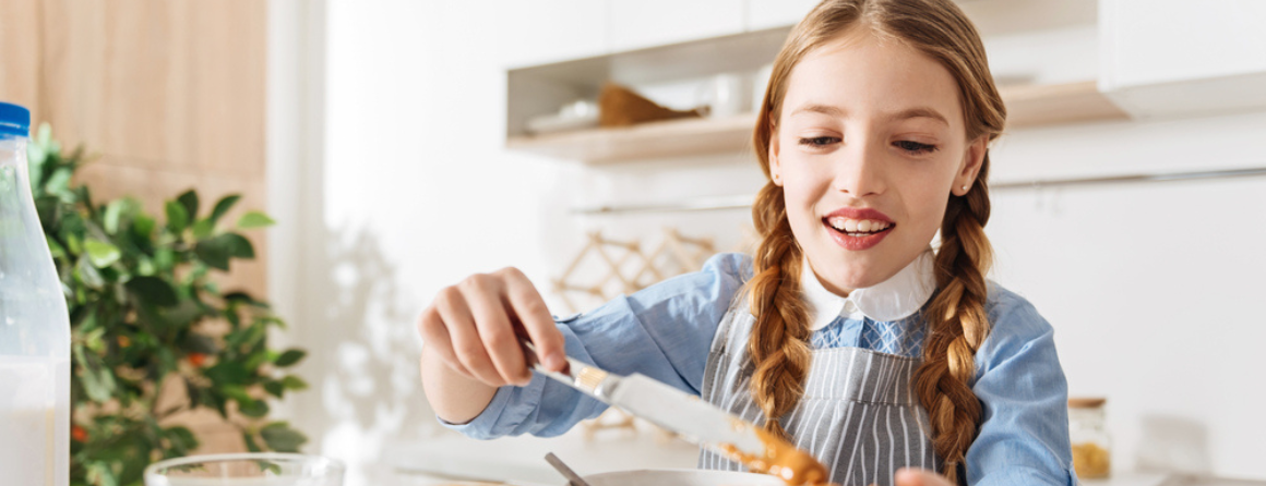 A child eating peanut butter on bread