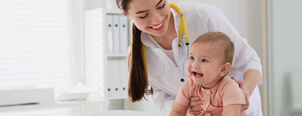 An infant is checked by a doctor