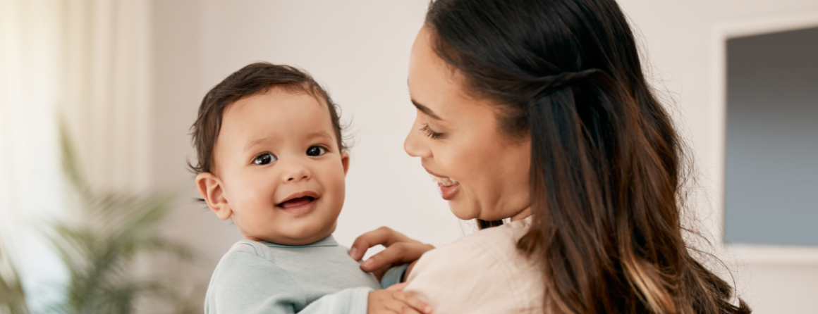 Mother holding smiling baby