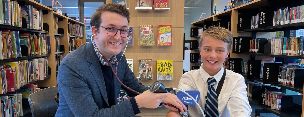 Jonathan Glenning checks a child's blood pressure in a library