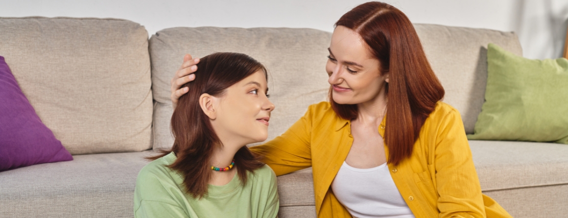 Mother comforting young teenager