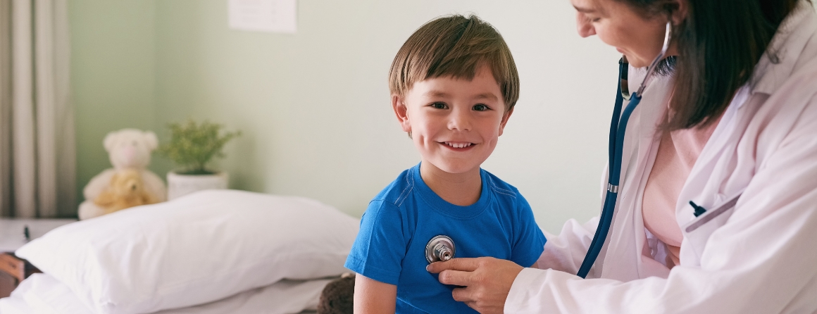 A child has their heart checked by a doctor