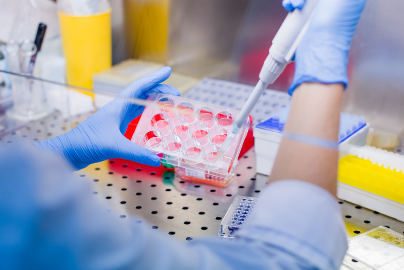 Scientist with pipettes in a lab 