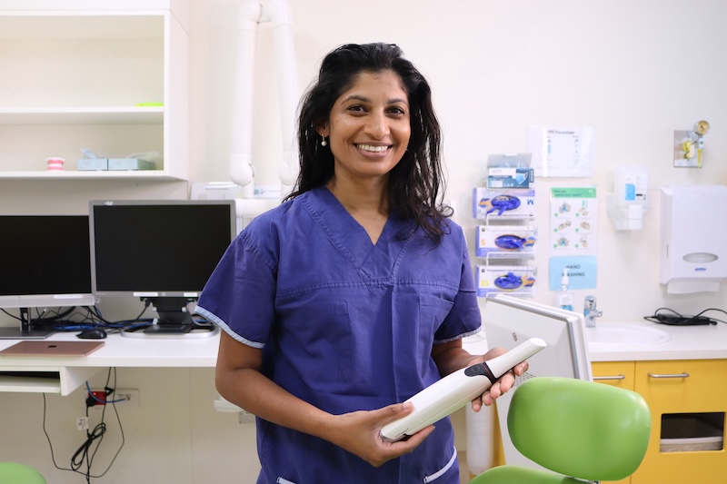 Child oral health expert Associate Professor Mihiri Silva holding the new oral scanner to be used with 3D AI dental software
