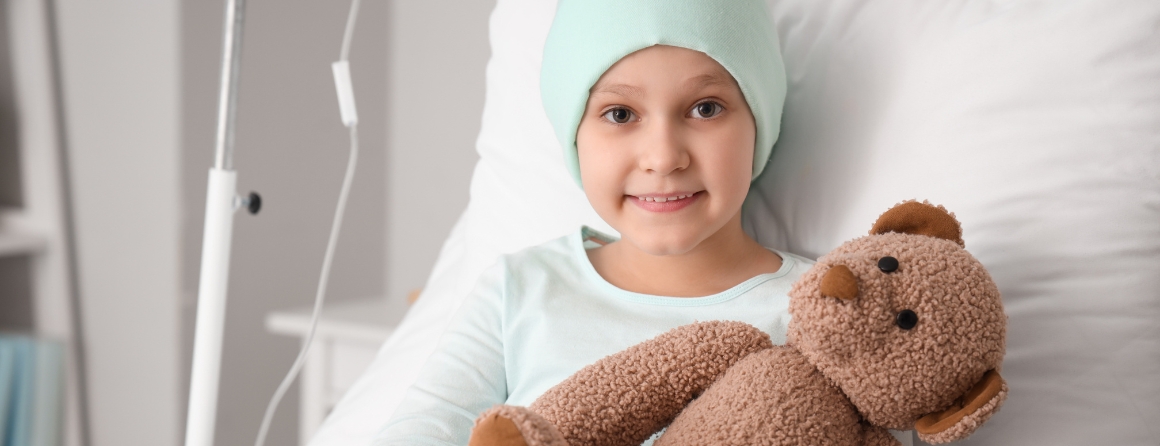 A child with cancer in hospital with a teddy bear