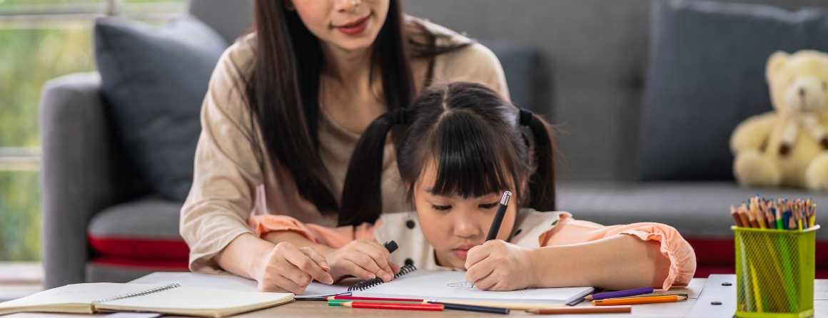 A mother helps a child with homework