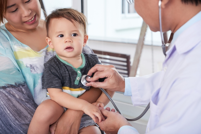 A child has their heart checked by a doctor