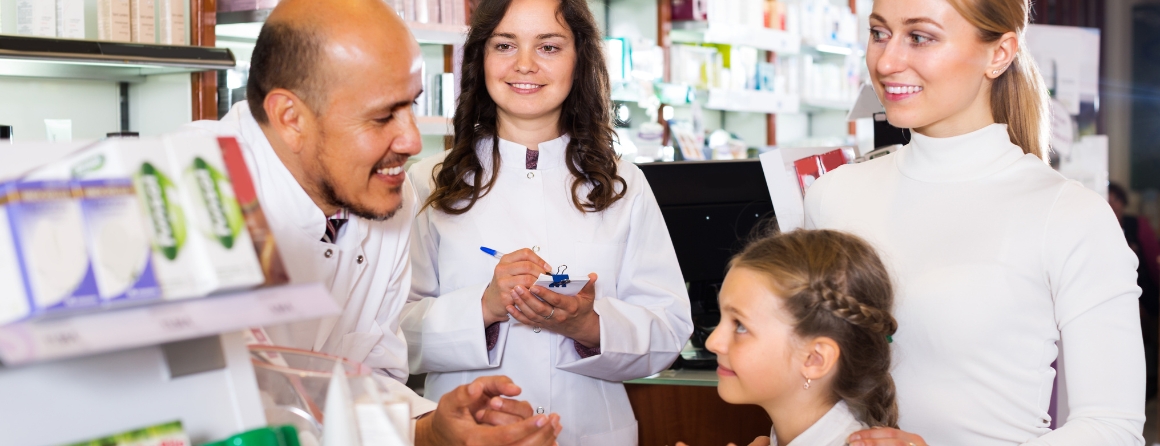 A pharmacist speaks with three children