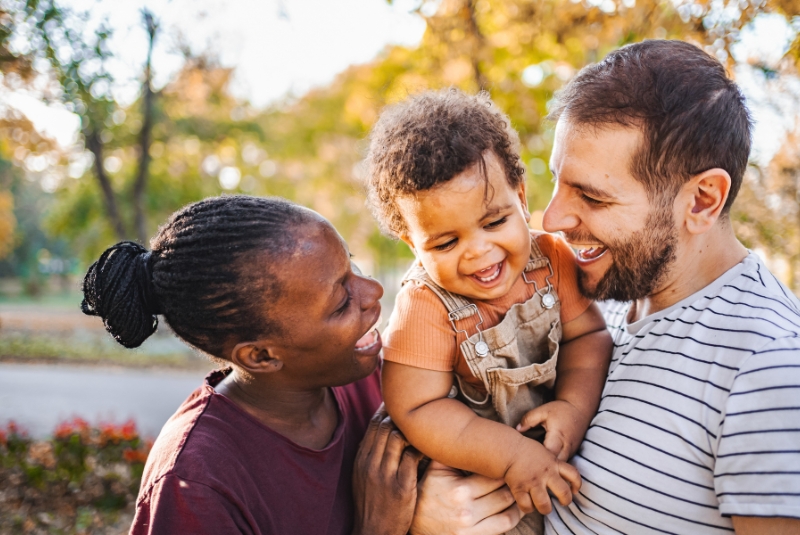 Two parents holding their child