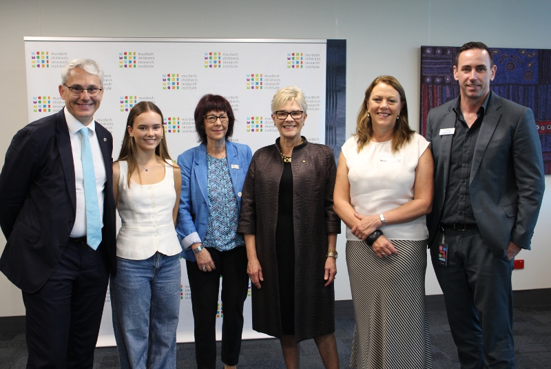 Victorian Minister Danny Pearson, Indigo, Prof Vicki Anderson, Prof Kathryn North AC, AFL Head of Concussion Innovation and Research Cathy Willmott and RCH Chief Allied Health Officer Doug McCaskie at the MCRI announcement.